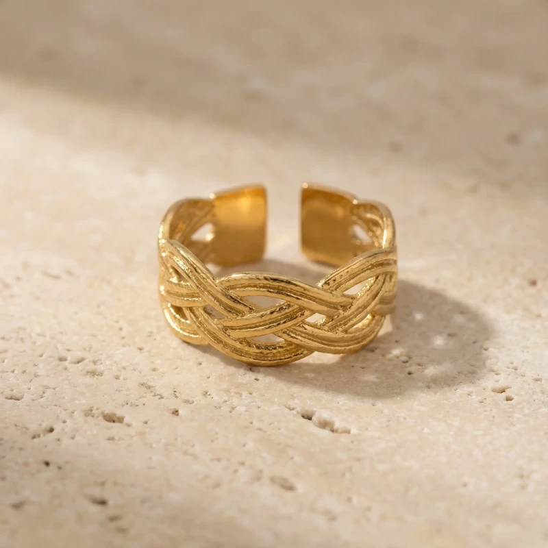 Złoty pierścionek regulowany ze stali chirurgicznej z szeroką obrączką o strukturze przeplatanej plecionki (warkocza)a.webp